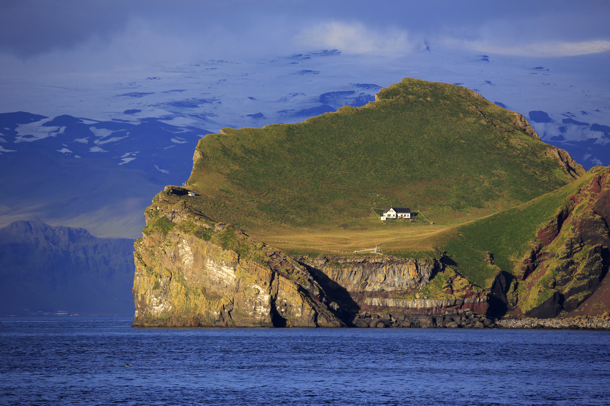 A lone house on a rocky, hilly landscape