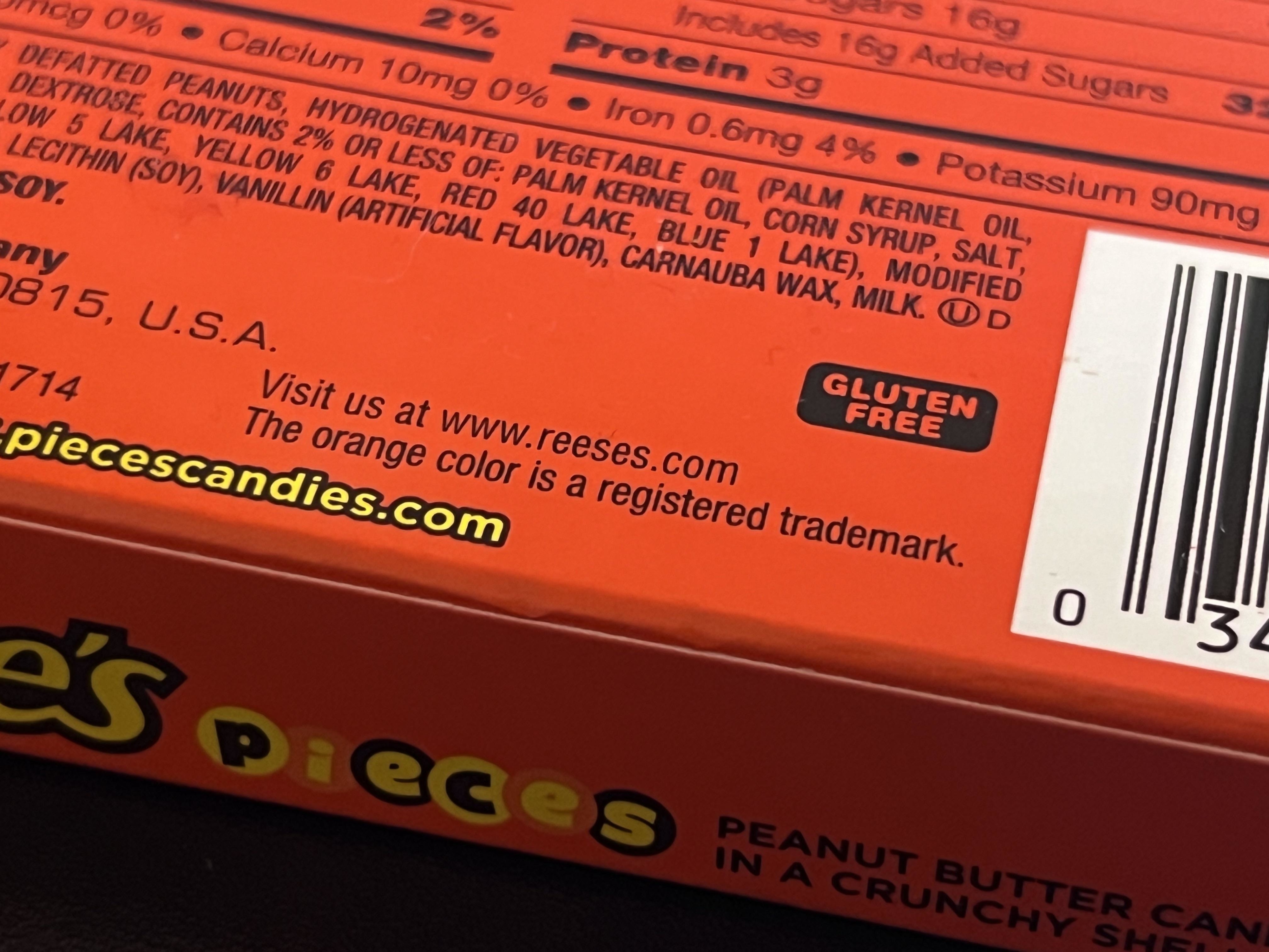 Close-up of the Reese&#x27;s candy wrapper saying, &quot;The orange color is a registered trademark&quot;