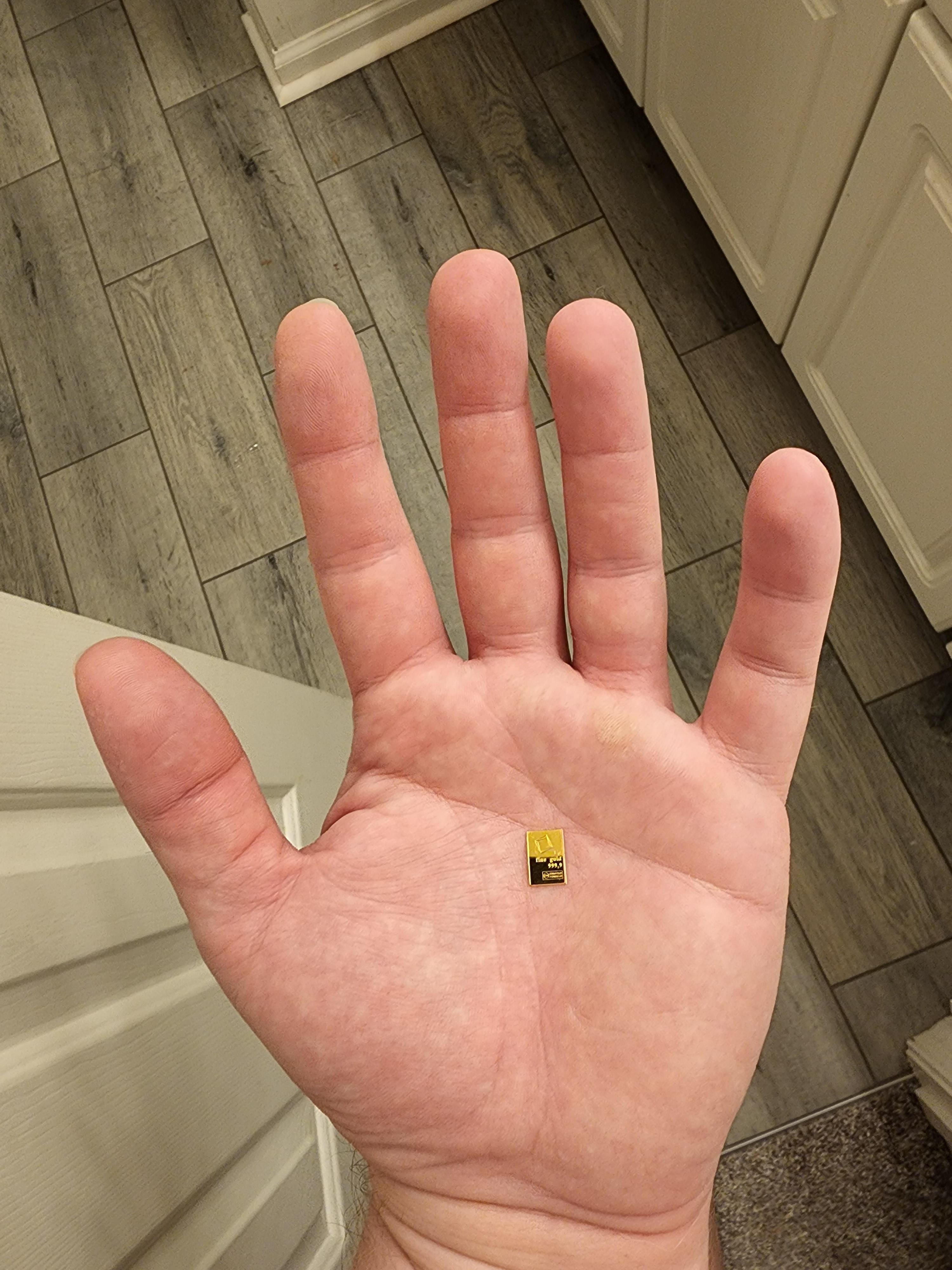 A tiny rectangular dot in the middle of a person&#x27;s palm