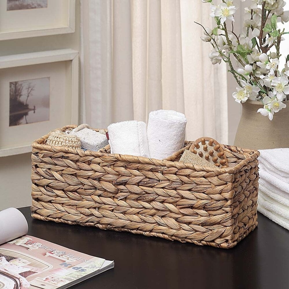 the woven basket holding towels and other items