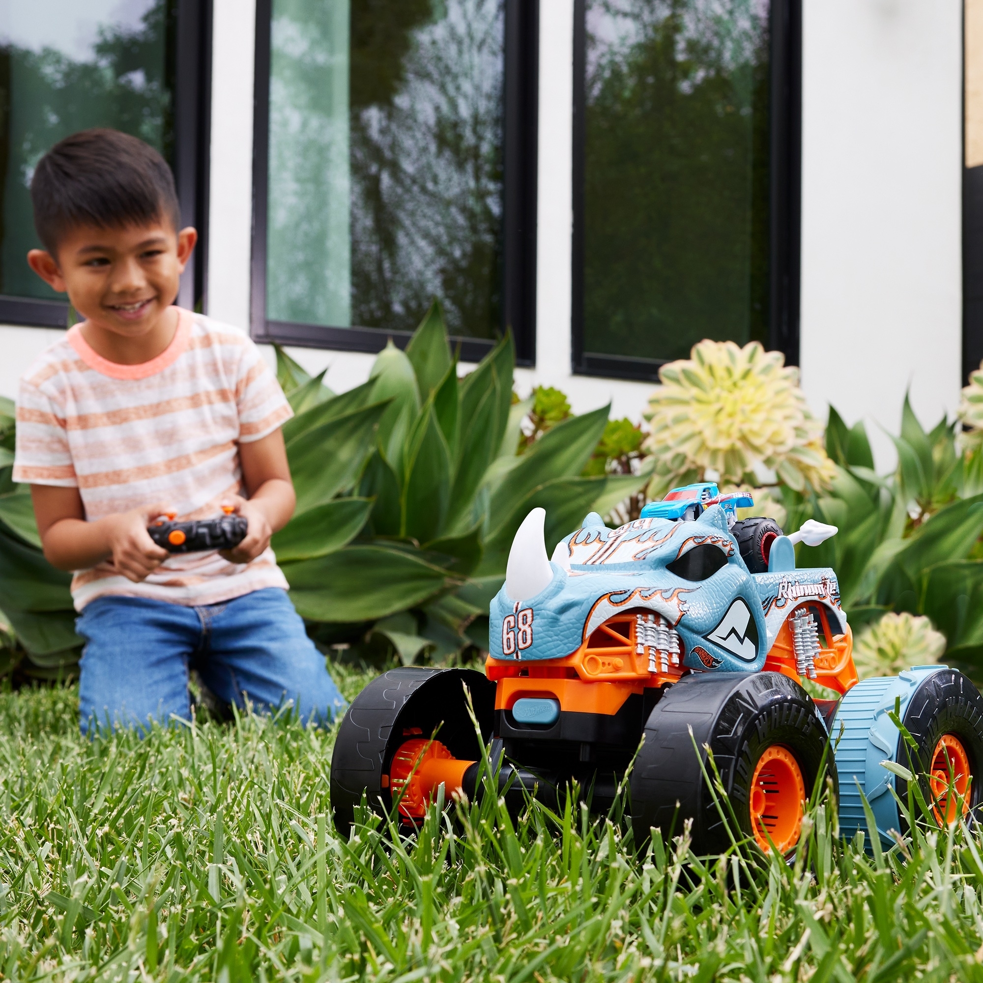 a kid uses a remote control to play with the transforming monster truck