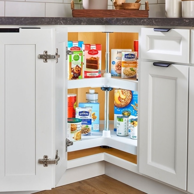 white Lazy Susans with pantry products in kitchen cabinet