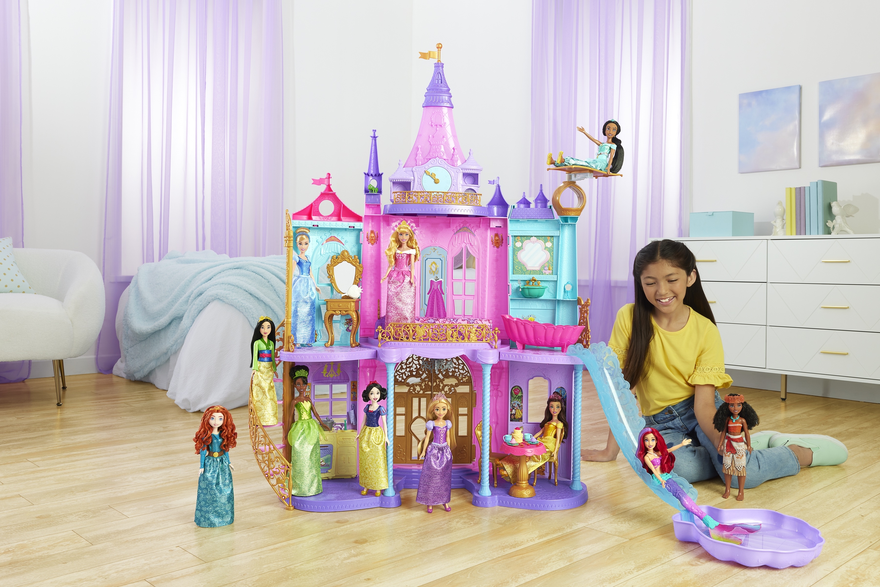 a child playing with the disney princess dollhouse