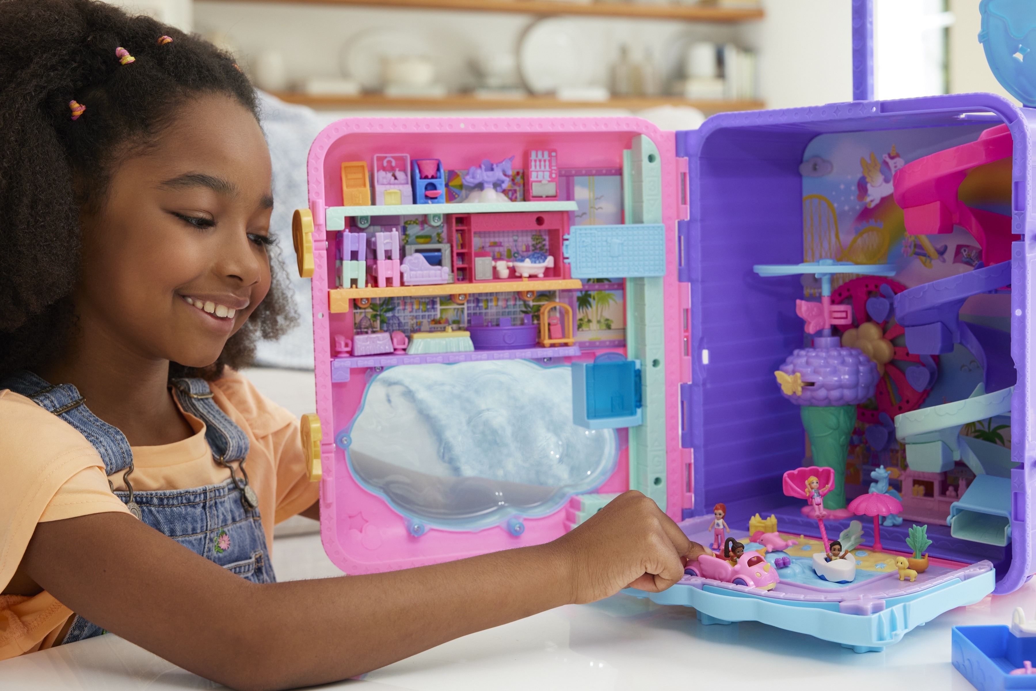 a child plays the polly pocket playset open to show what&#x27;s inside