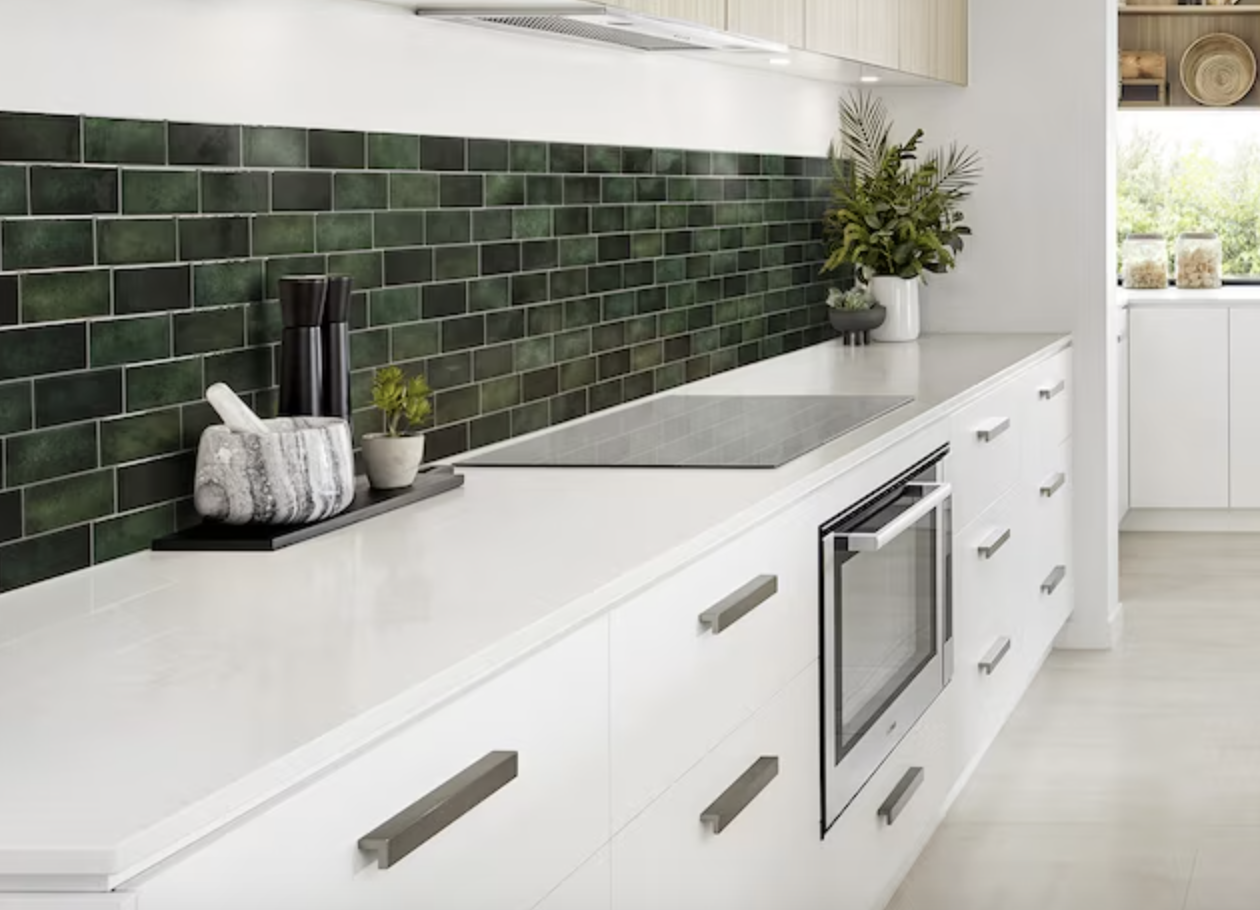 green peel-and-stick tiles in kitchen with white cabinets