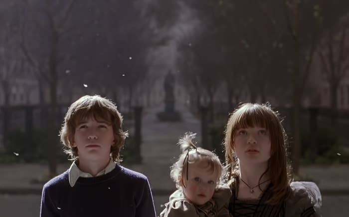 The Baudelaire children are walking up the steps