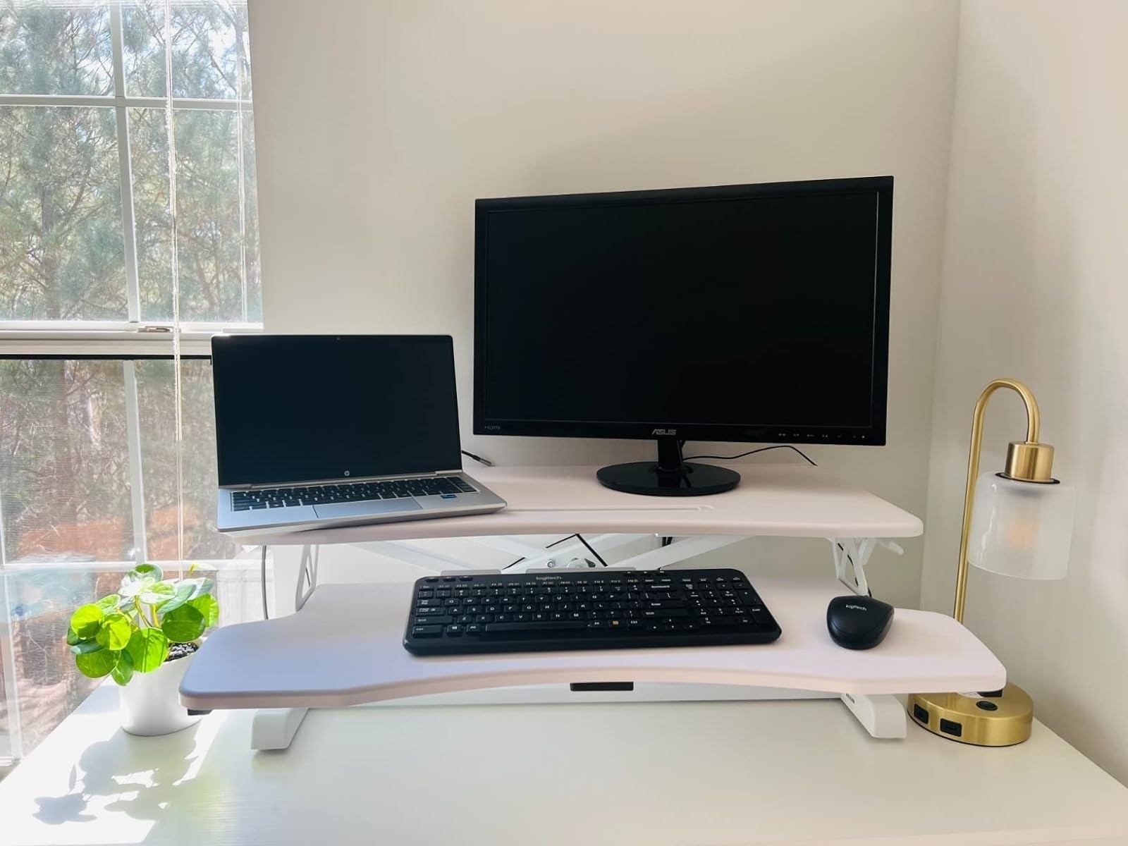 white standing desk converter with level for computer monitor and laptop and another level for keyboard