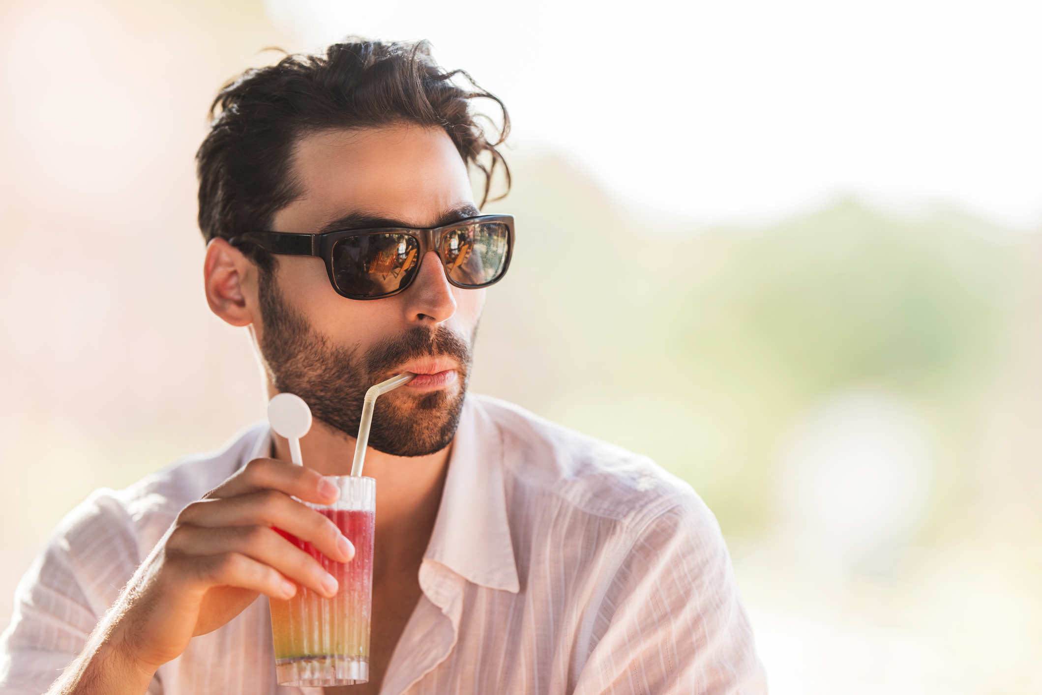 A man drinking a beverage