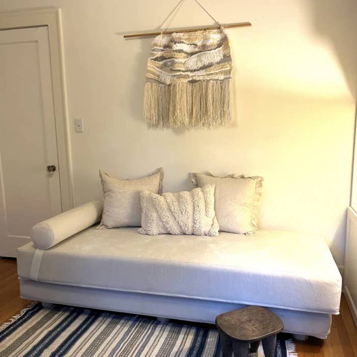 white daybed with white pillows in room