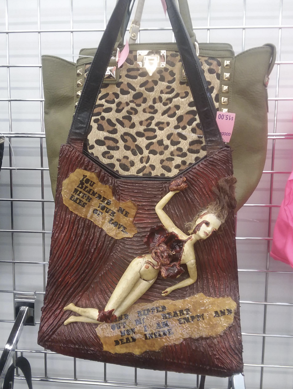 a bag with a bloodied barbie doll attached to it