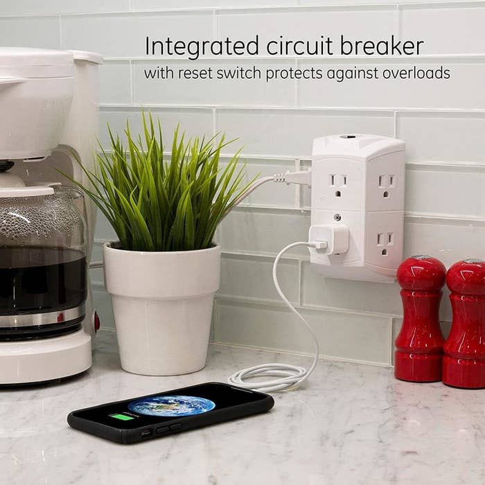the outlet extender plugged into a partition with substance speechmaking "integrated circuit breaker with reset power protects against overloads"