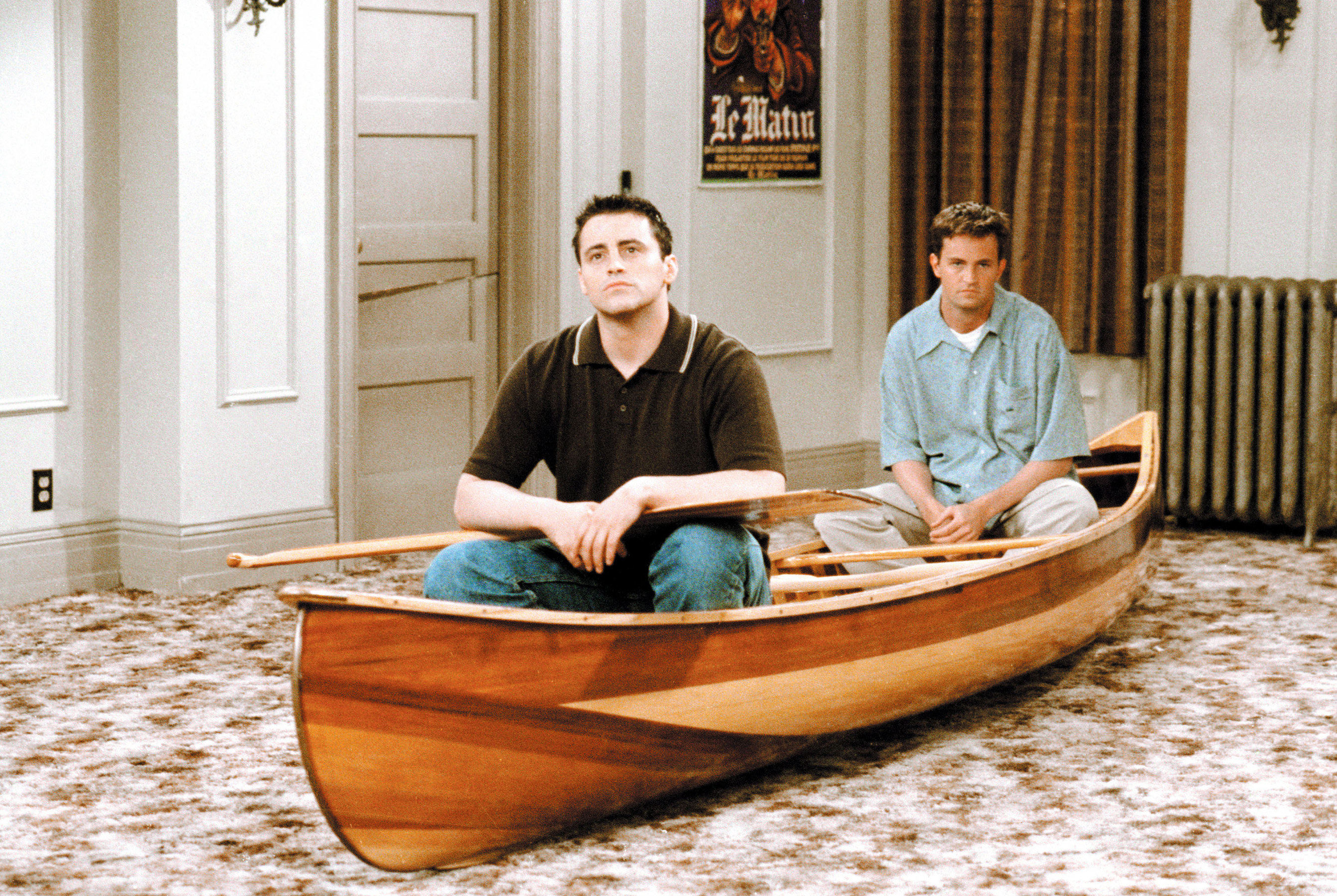 their characters sitting in a canoe in their apartment