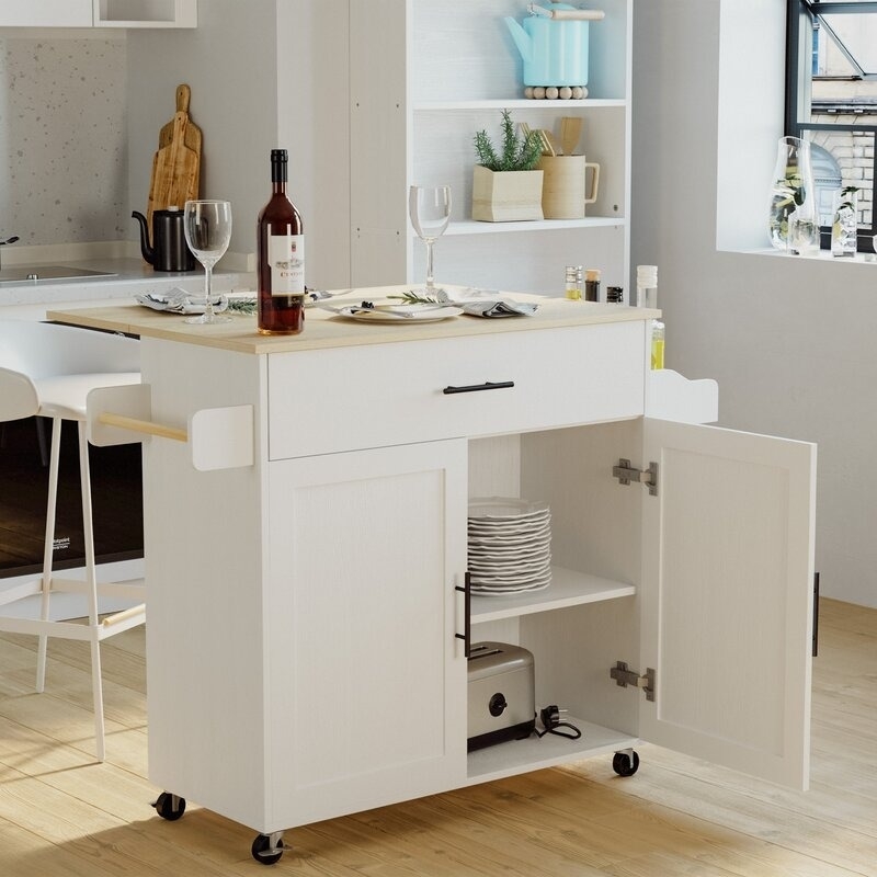 white kitchen island with drawer on top and cabinet and shelves on the bottom