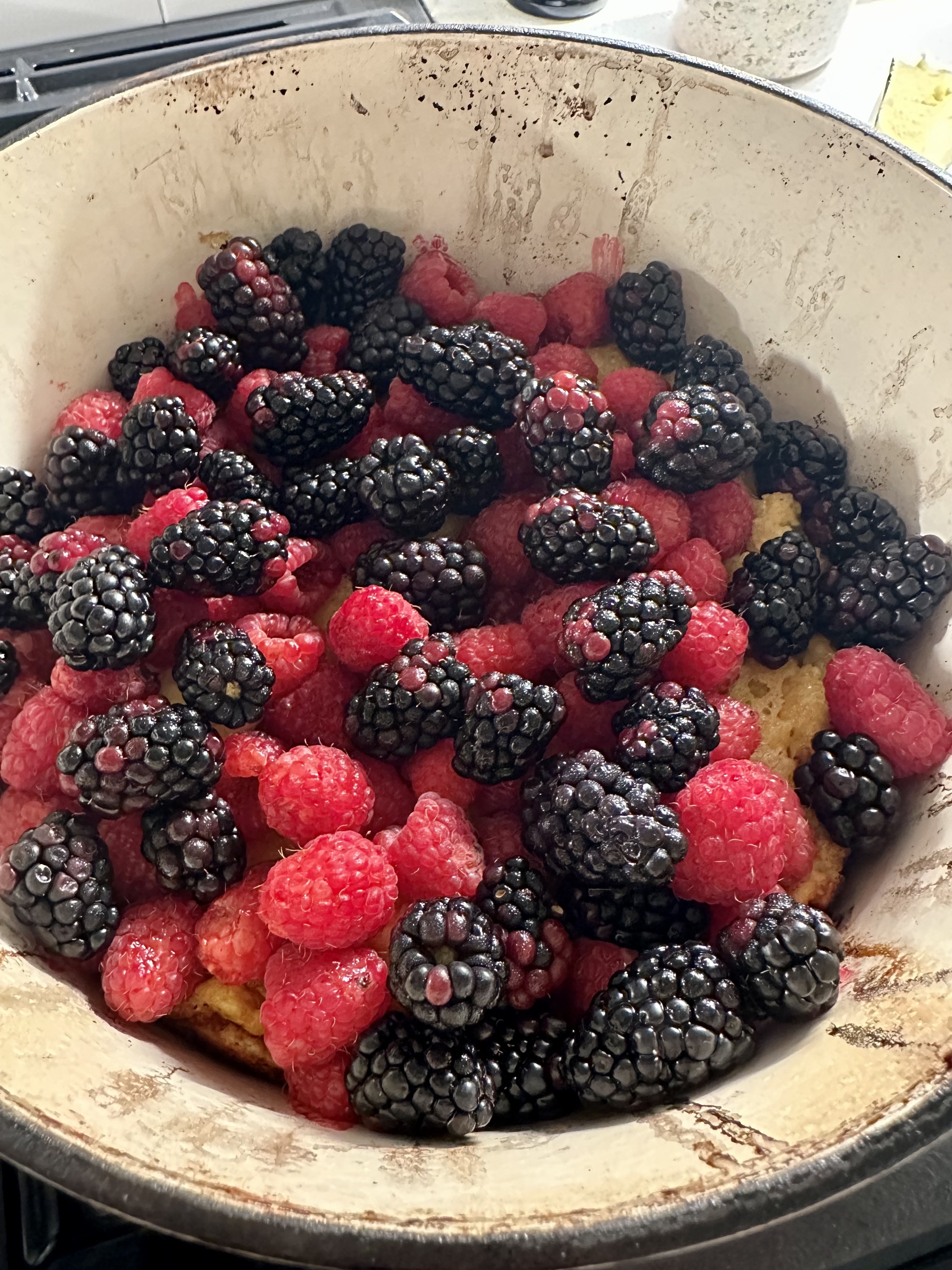 dutch baby topped with blackberries and raspberries