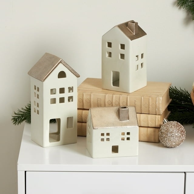 three of the ceramic houses on a dresser