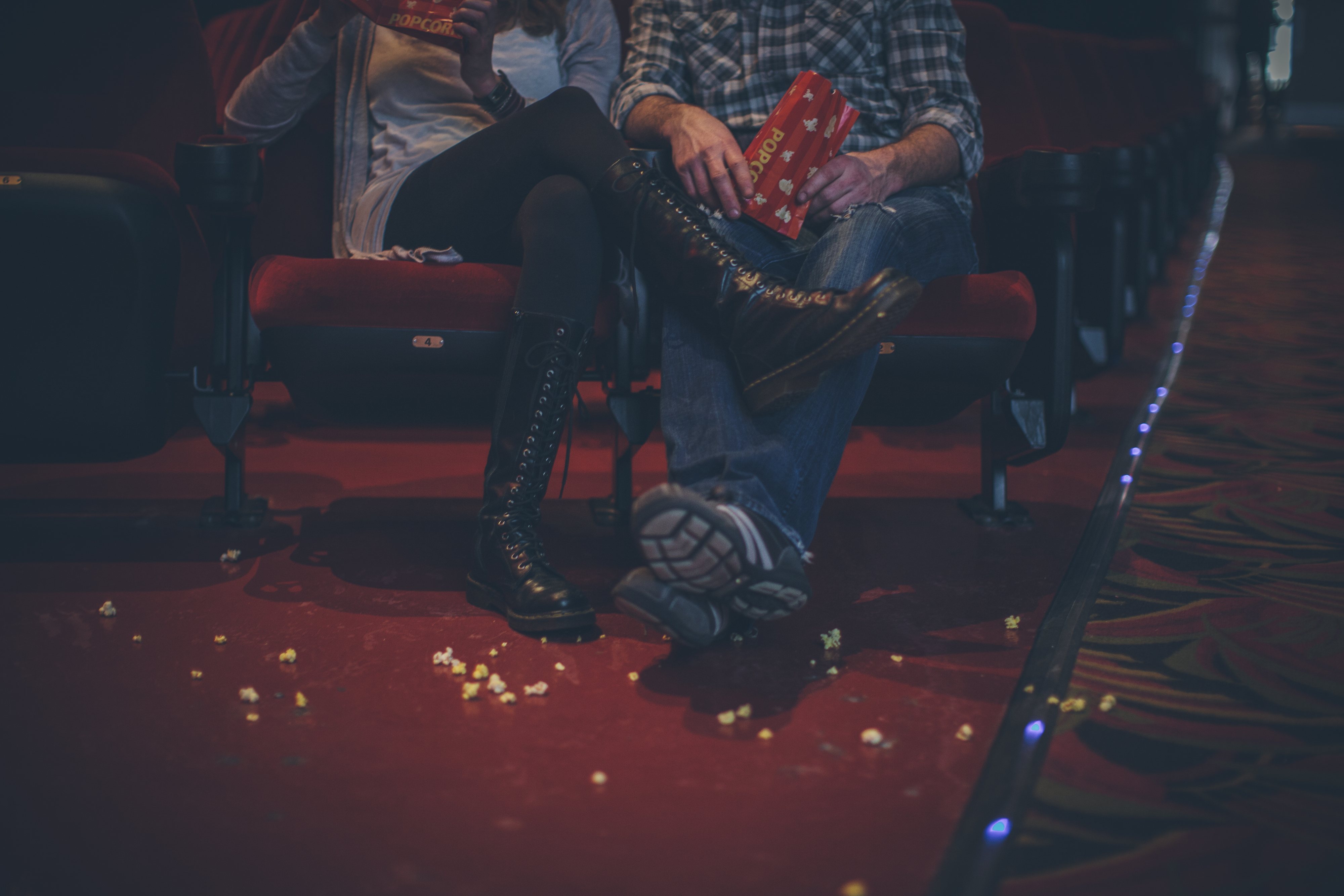 two people watching a movie in a movie theater