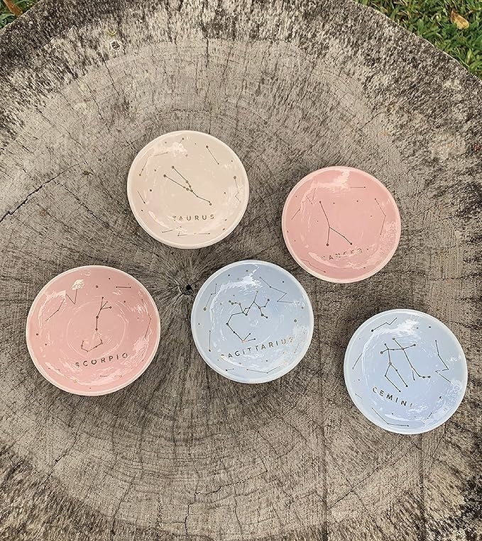 Jewelry dishes in various colors with different zodiac sign constellations on them