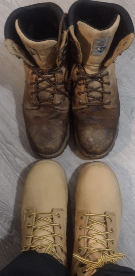 The old lace-up boots are an uneven dark brown, especially near the toes