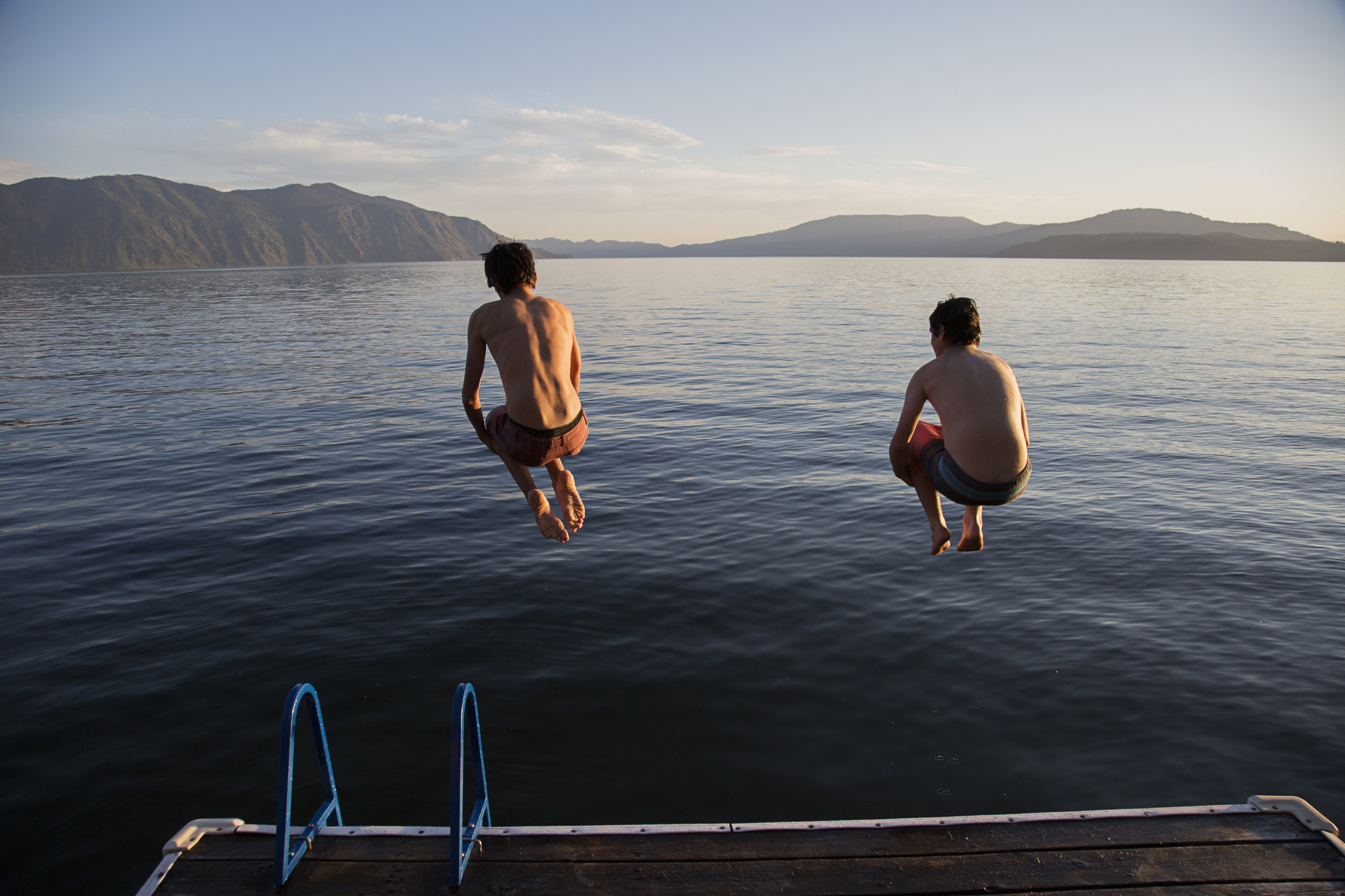 kids jumping into a lake