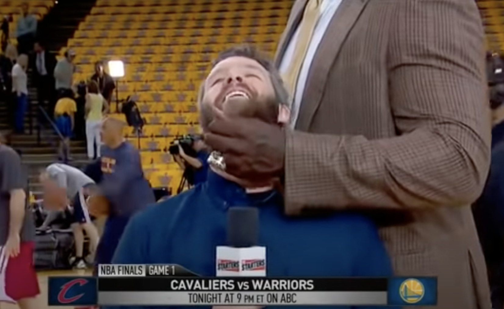 A reporter getting his beard caressed