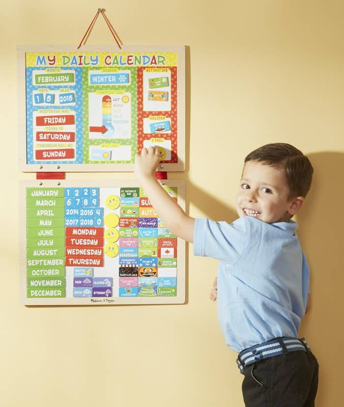 child using colorful magnetic calendar