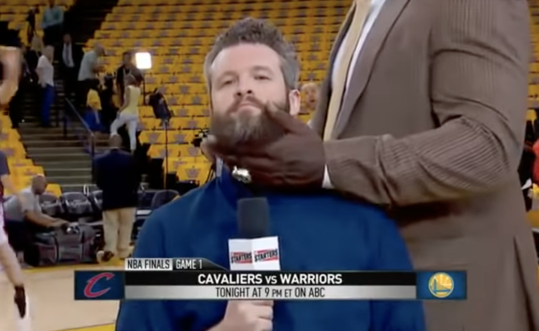 A reporter getting his beard caressed