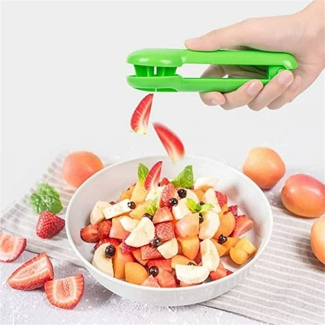 model using green fruit slicer to cut up strawberries and bananas