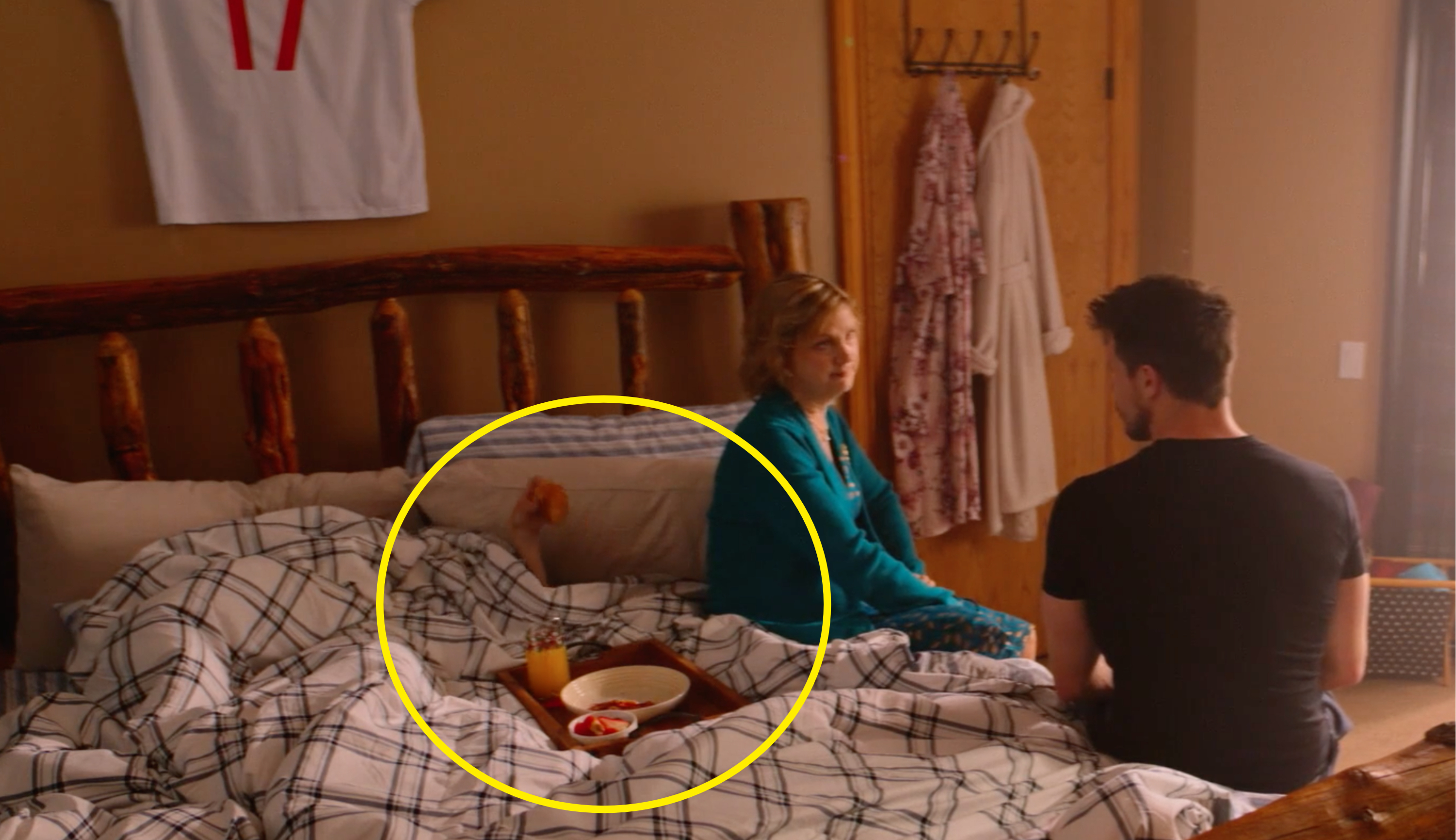 scene of person under bed sneaking a pastry while mother talks to son on bed