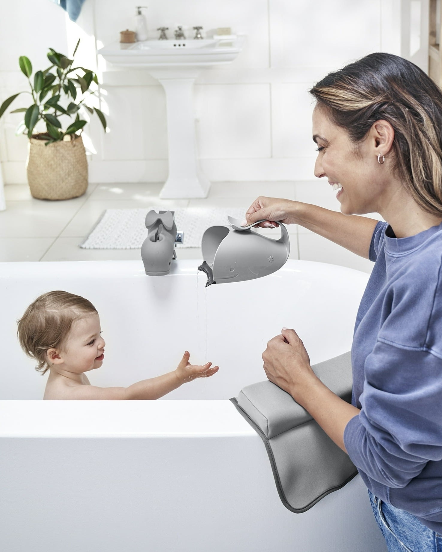 model using whale-shaped water container to give baby a bath