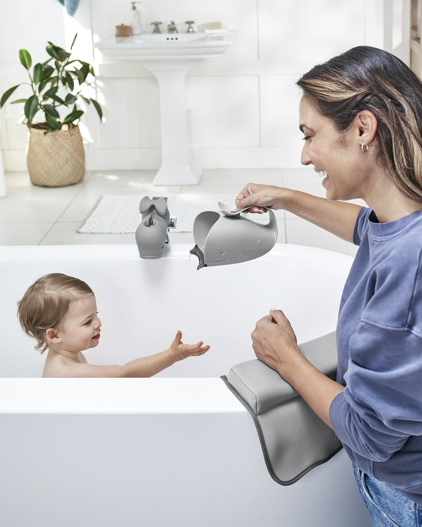 model using whale-shaped water container to give baby a bath