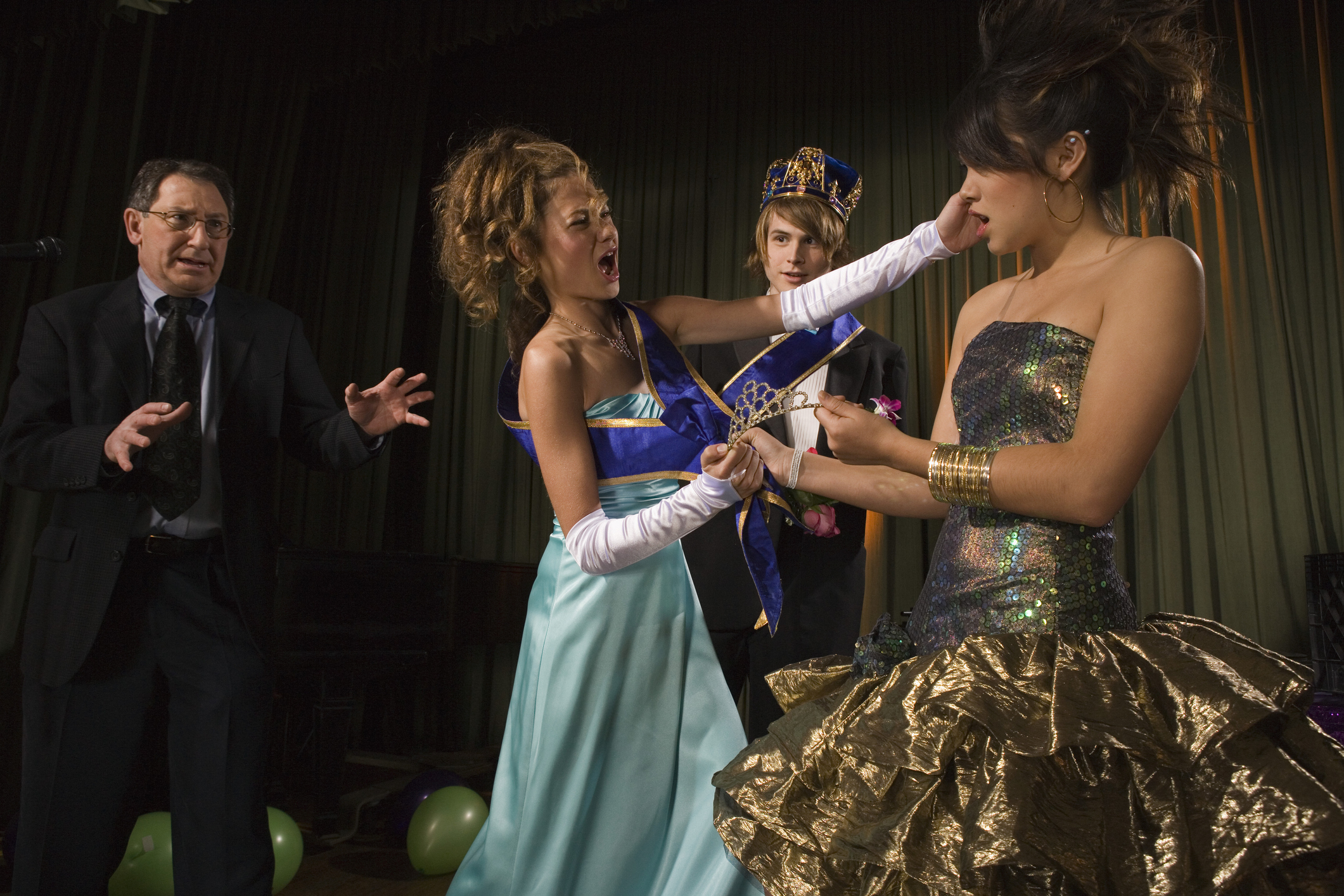 two girls fighting over a tiara on stage