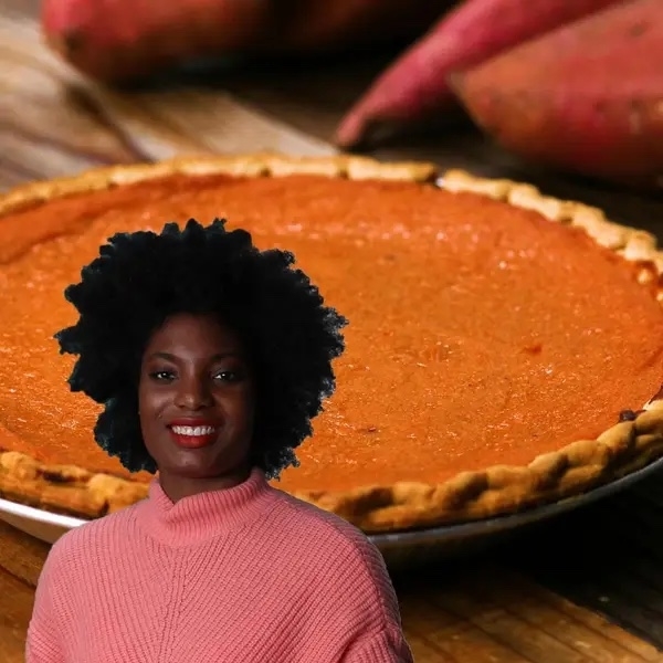 woman in sweater with pie in background