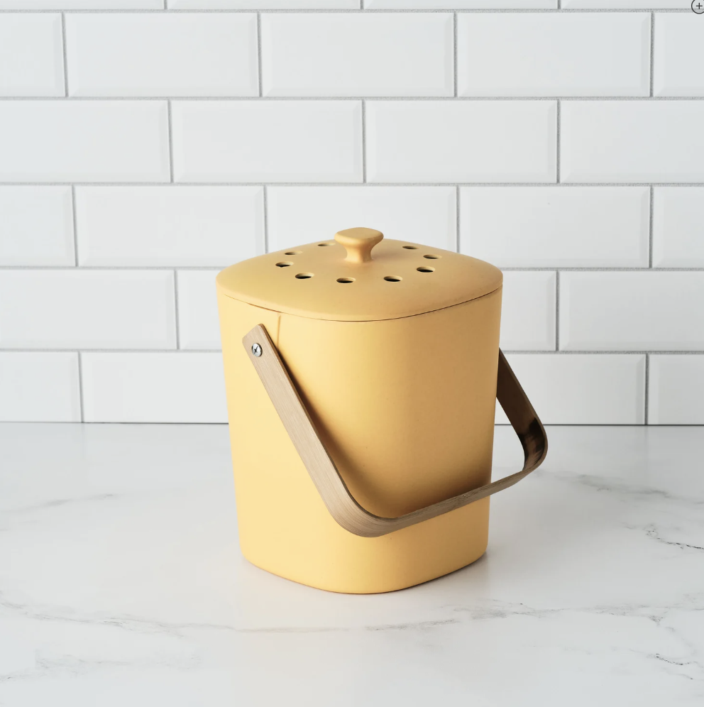 yellow composting bin on kitchen counter