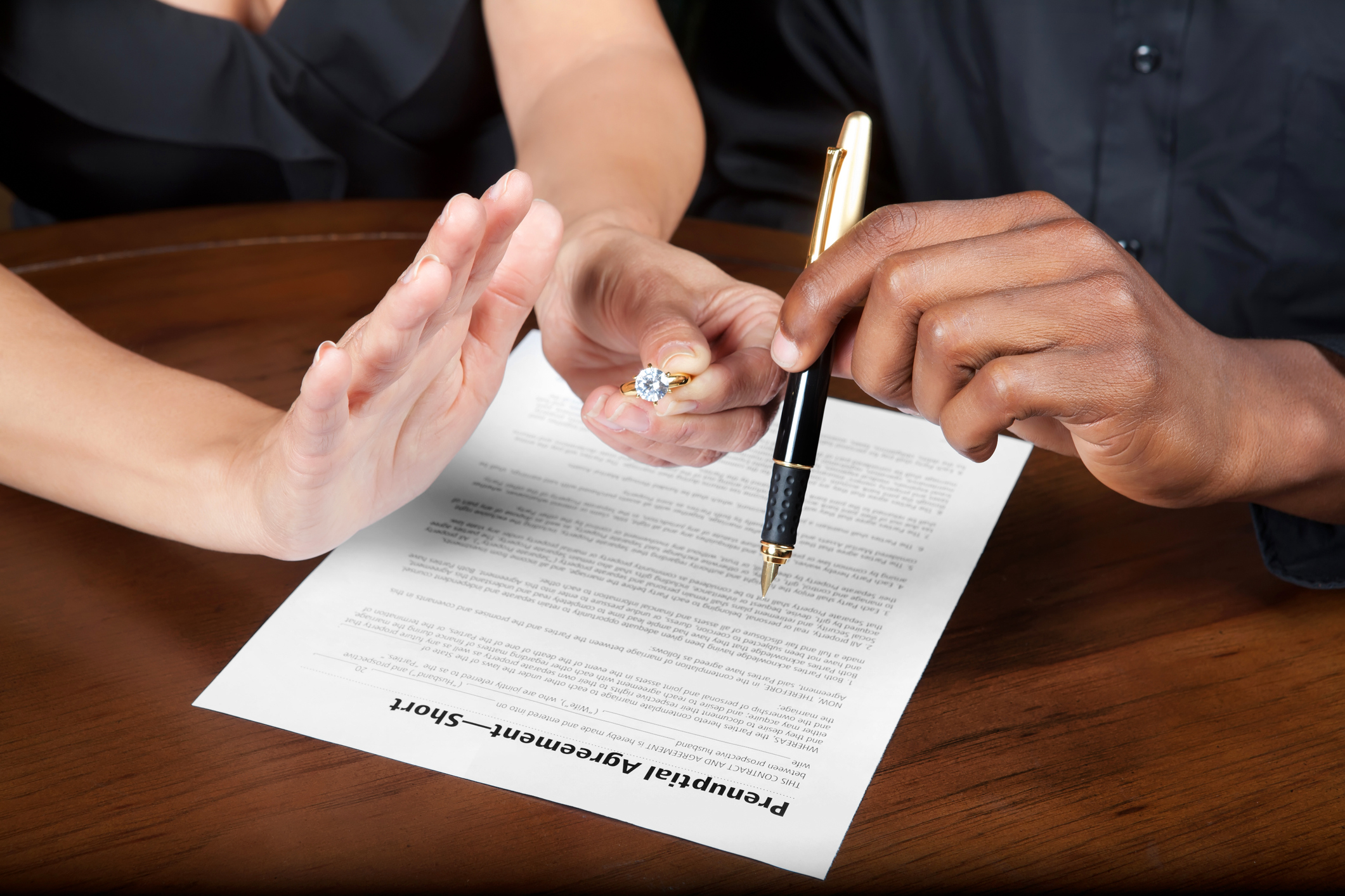 People signing a prenuptial agreement