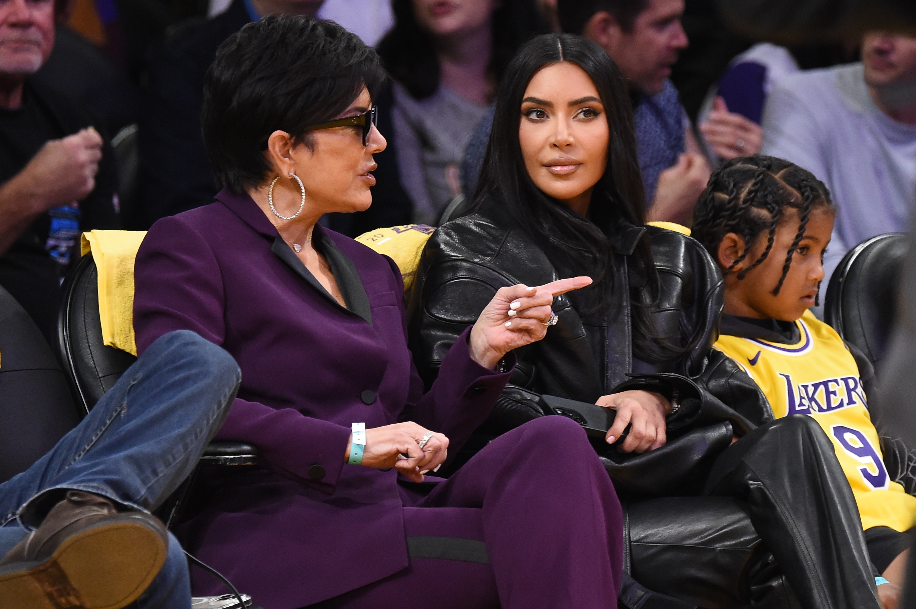 Kris Jenner, Kim Kardashian, and one of Kim&#x27;s kids at a game