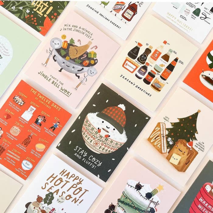 A bunch of holiday cards laid out with different illustrations on each