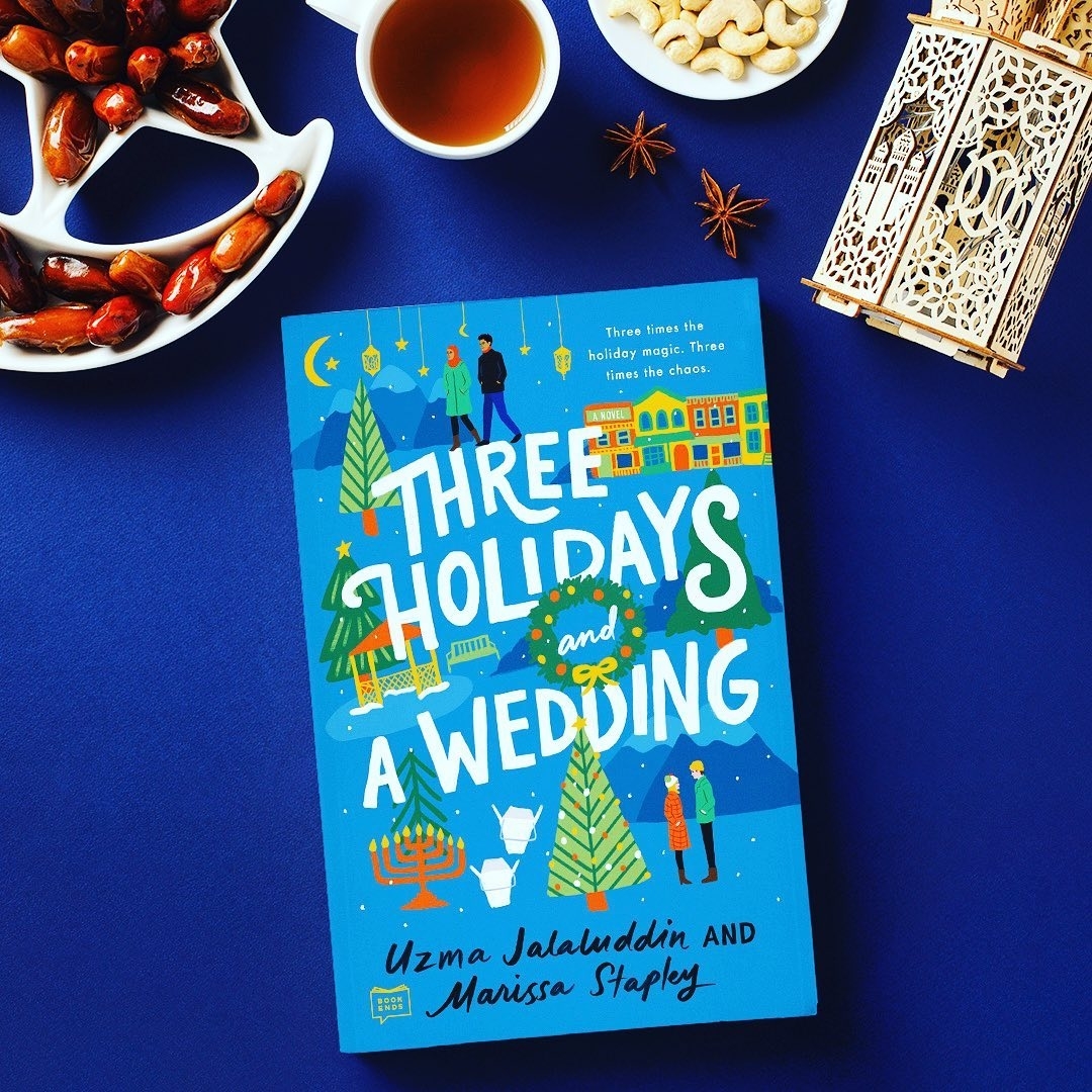 A copy of Three Holidays and a Wedding next to bowls of finger foods