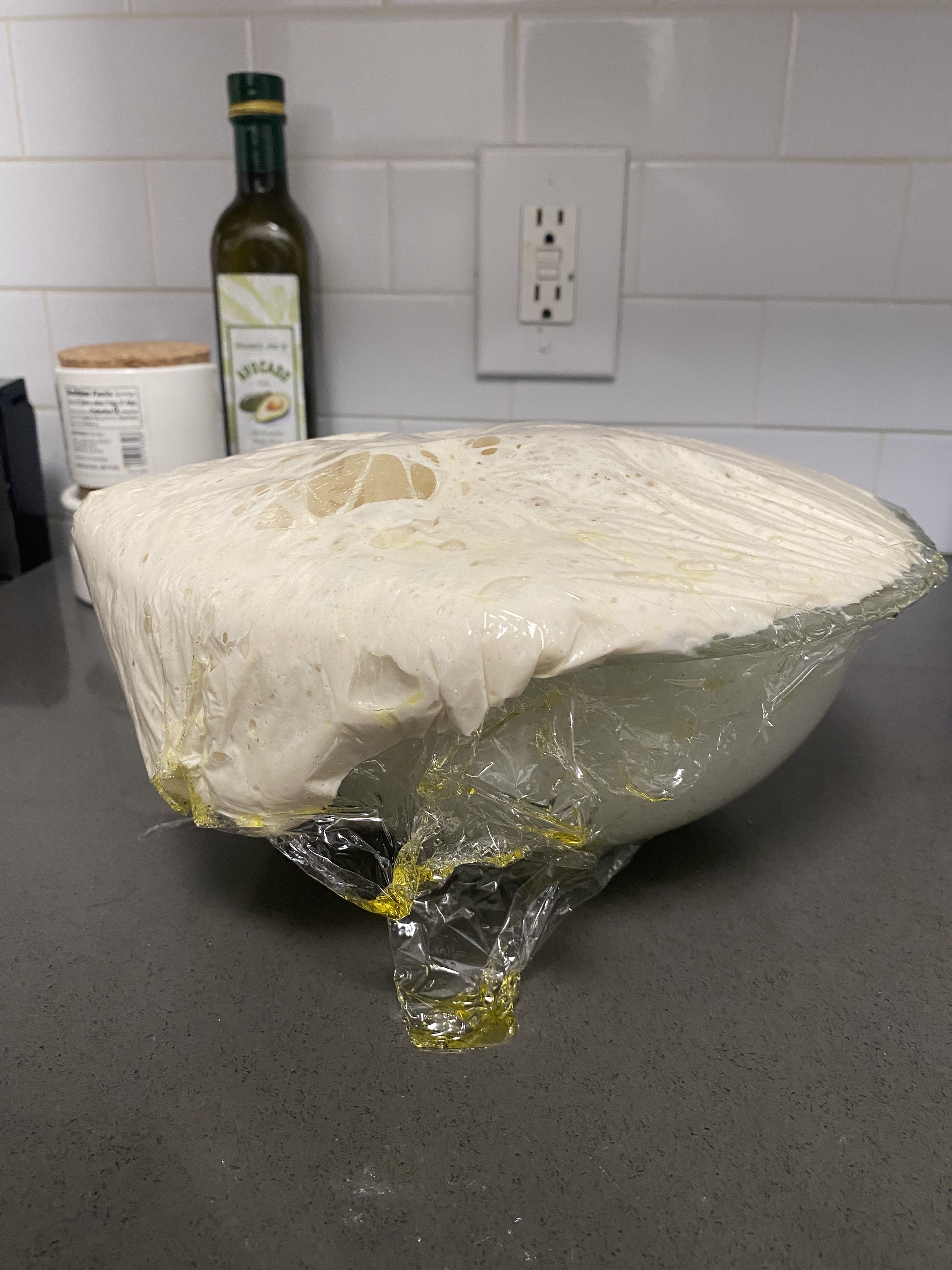 Overflowing dough in a plastic bowl