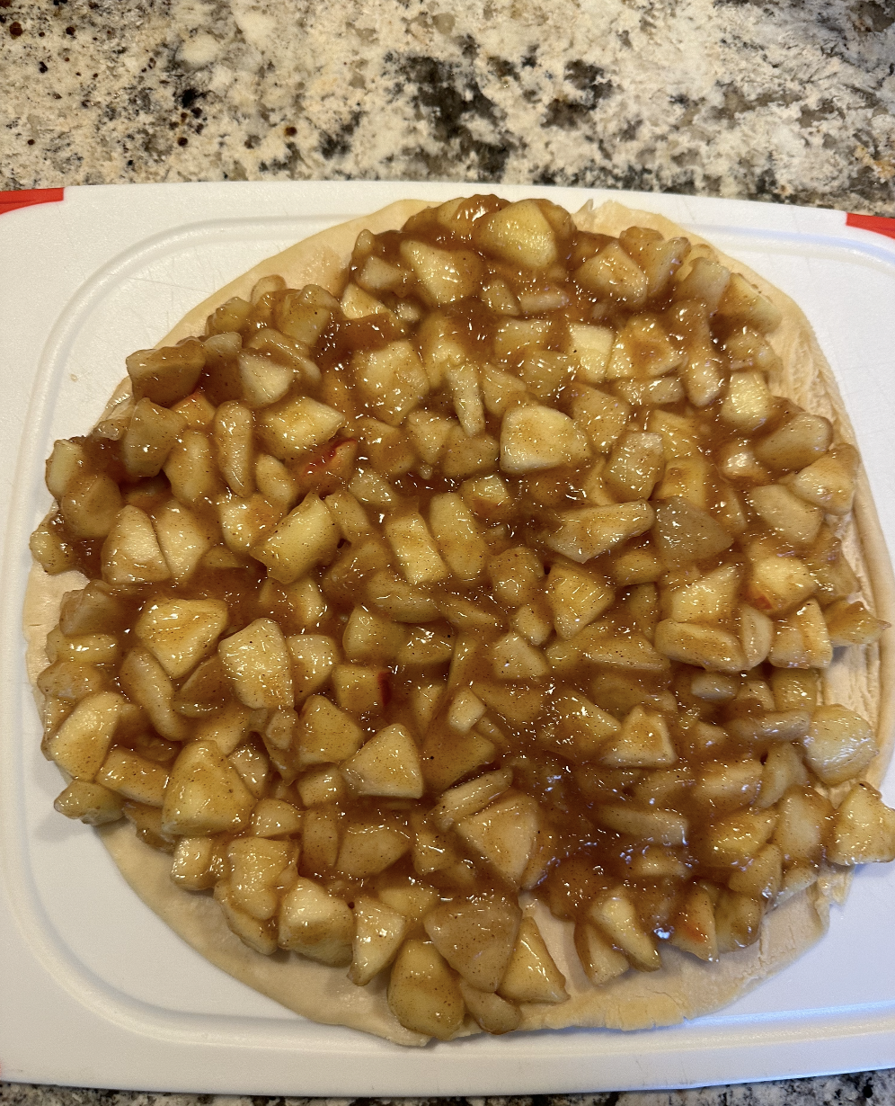 diced apples on a frozen pie crust