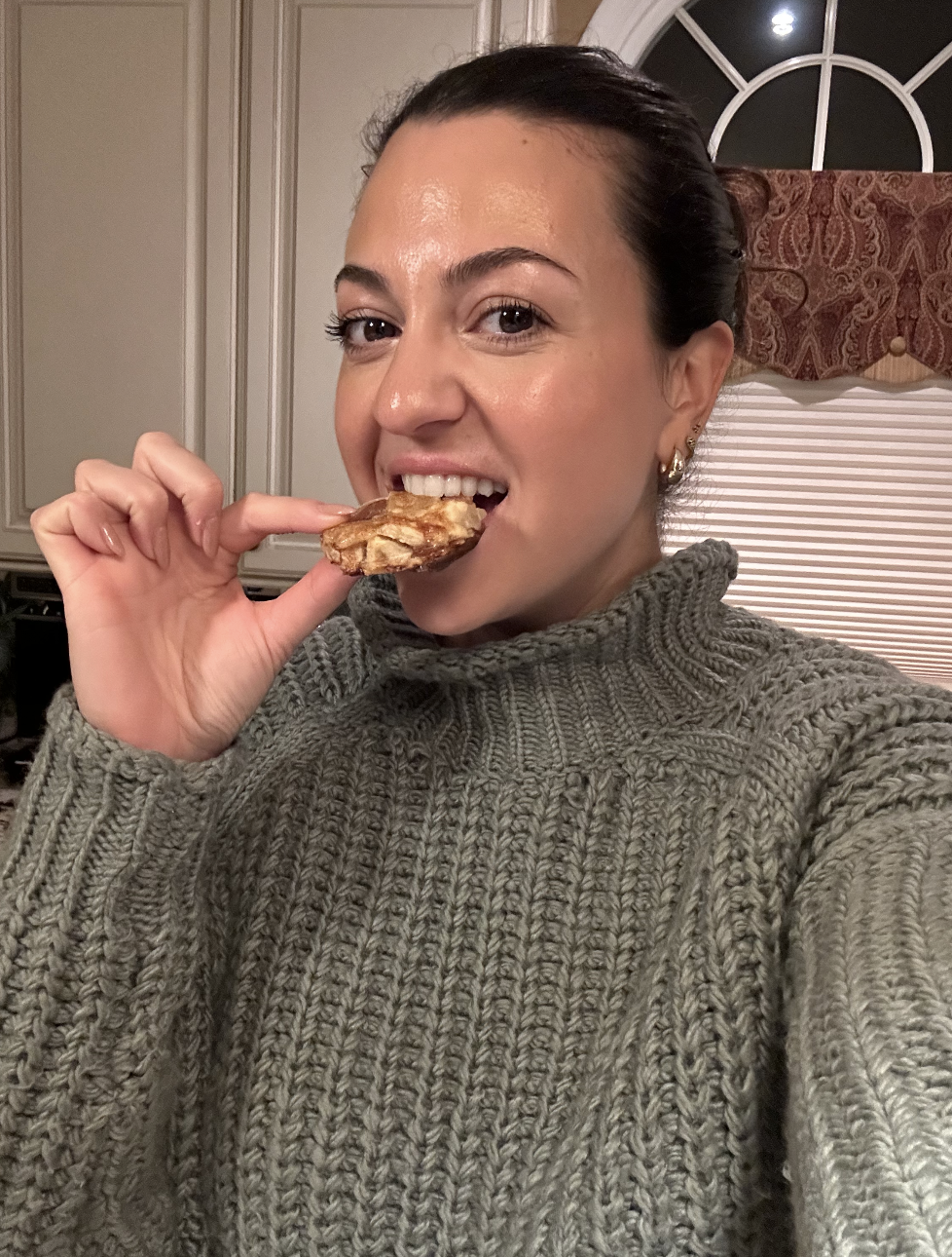 the author taking a bite out of a cookie