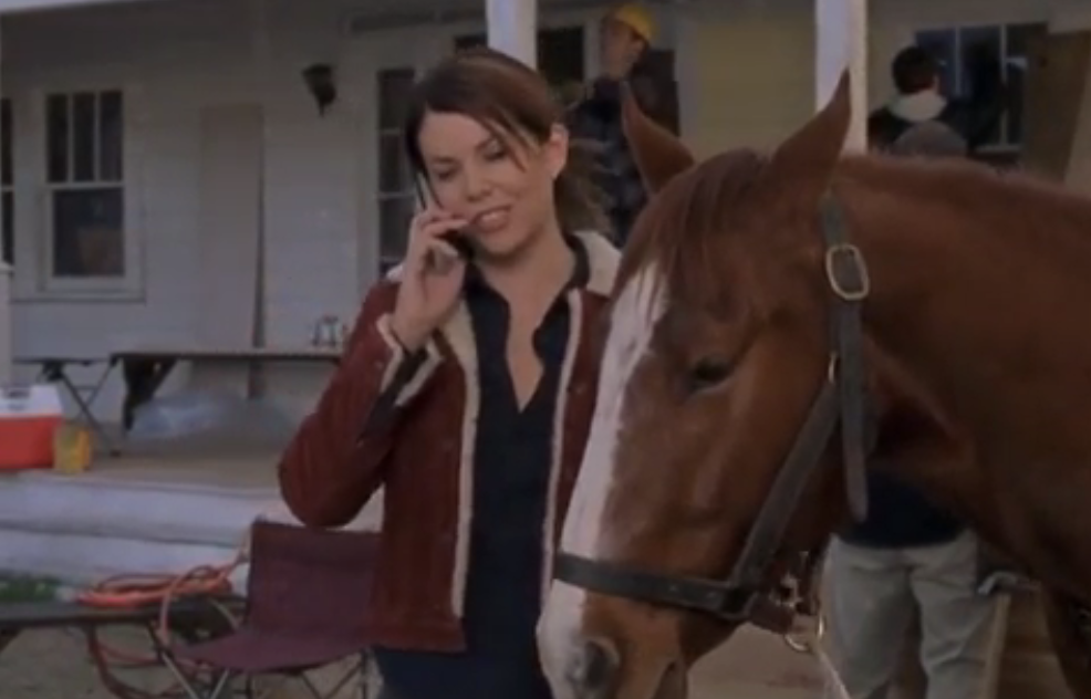 Lorelai Gilmore holding a horse
