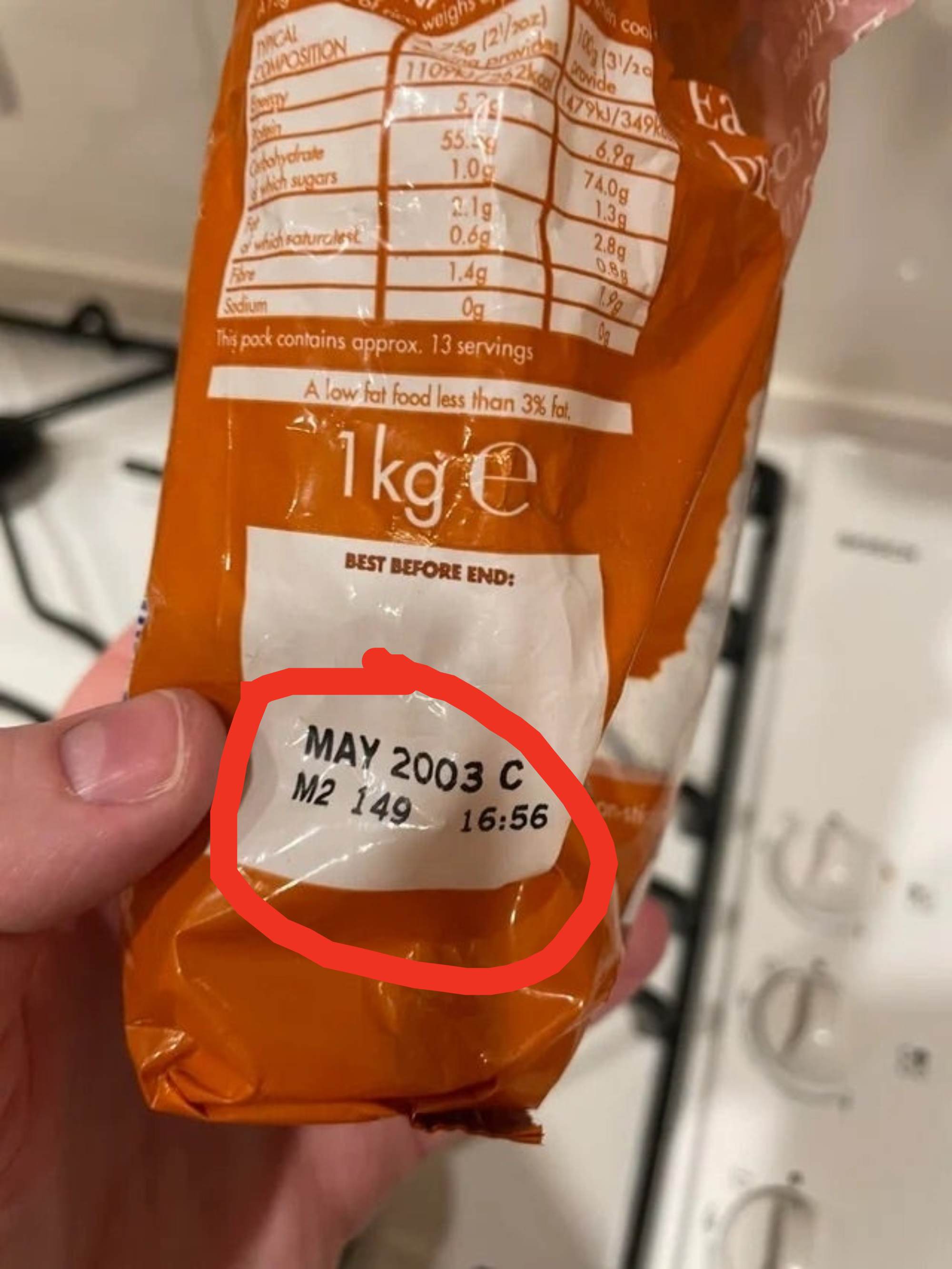 Someone holding a bag showing an expiration date of May 2003