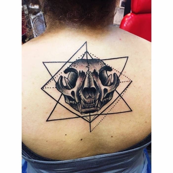 cat skull back tattoo