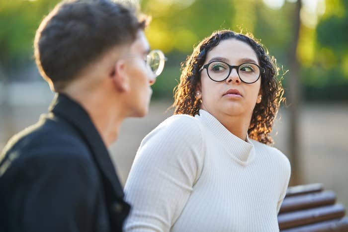 A woman jumping back in surprise at something a man did or said