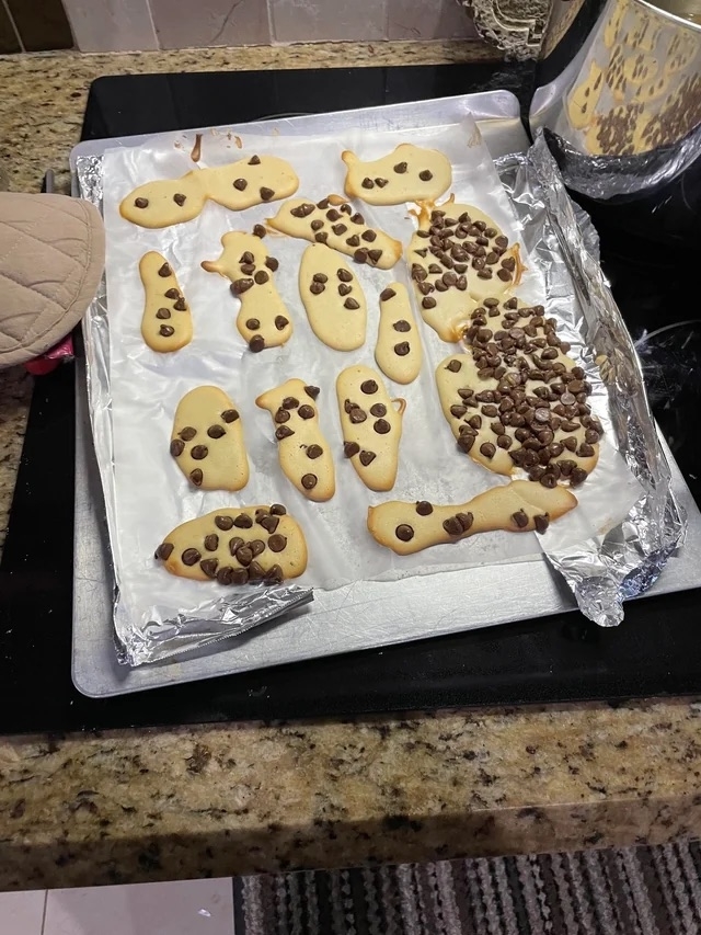 Misshapen pieces of chocolate chip dough on a baking tray