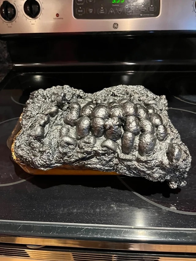 A dish covered in foil that's been burnt into the dish