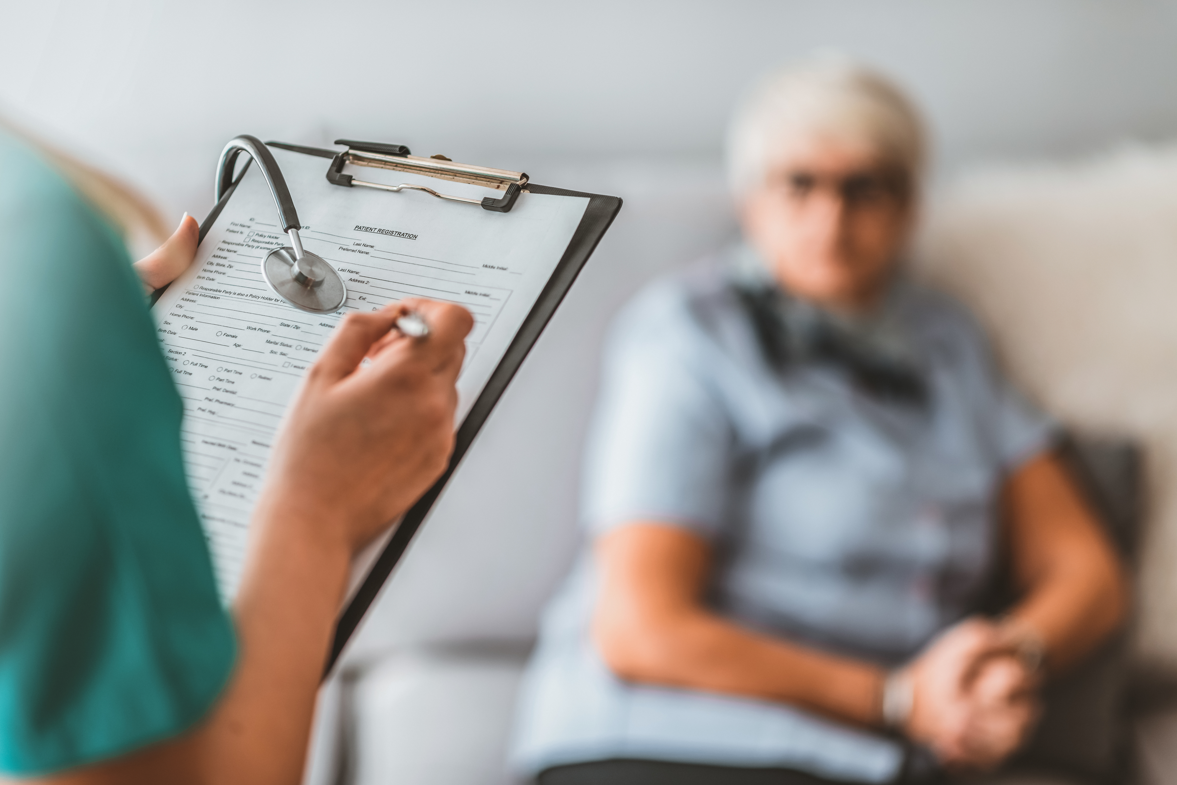 A nurse writing information on a patient's chart