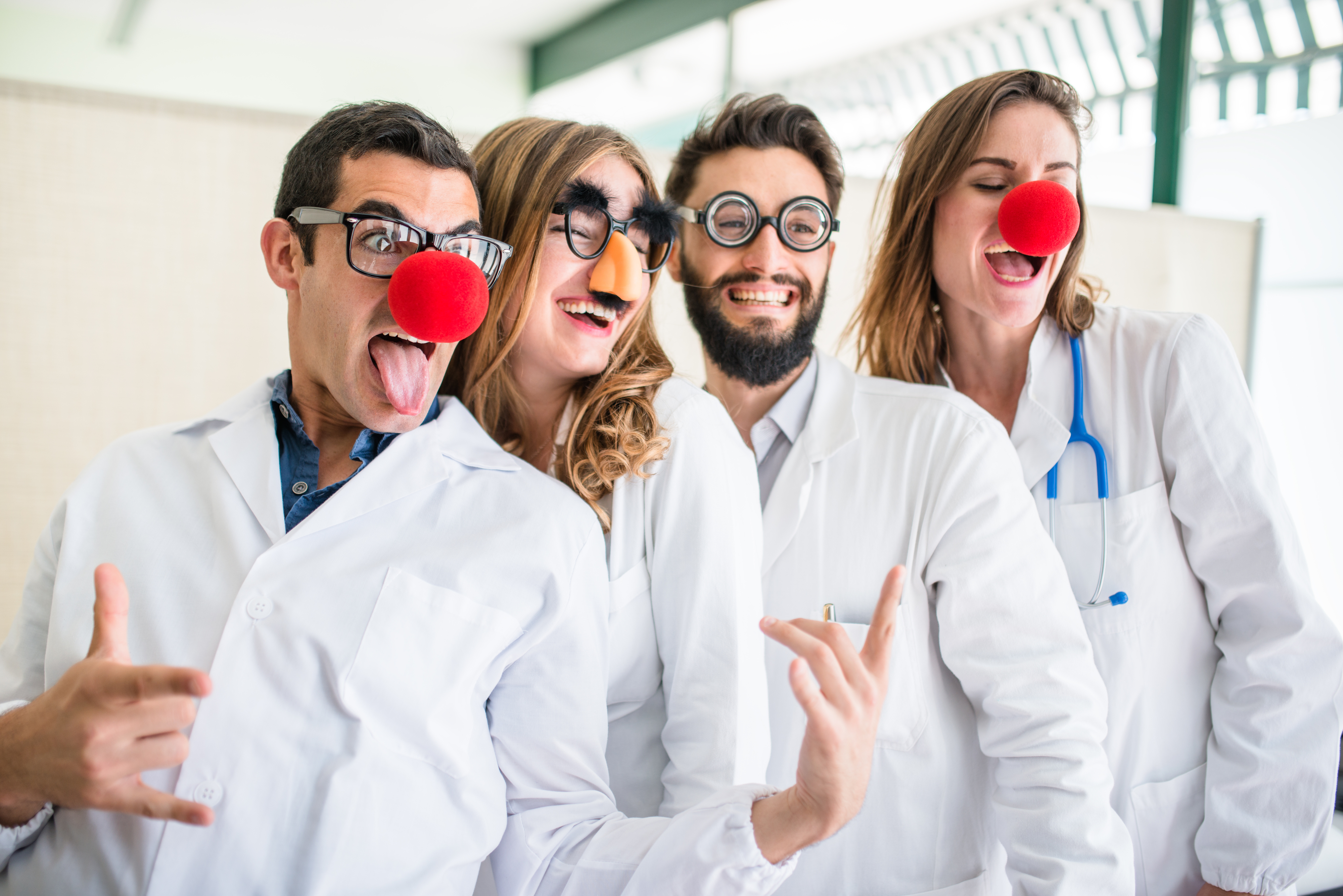 Doctors wearing silly glasses and clown noses