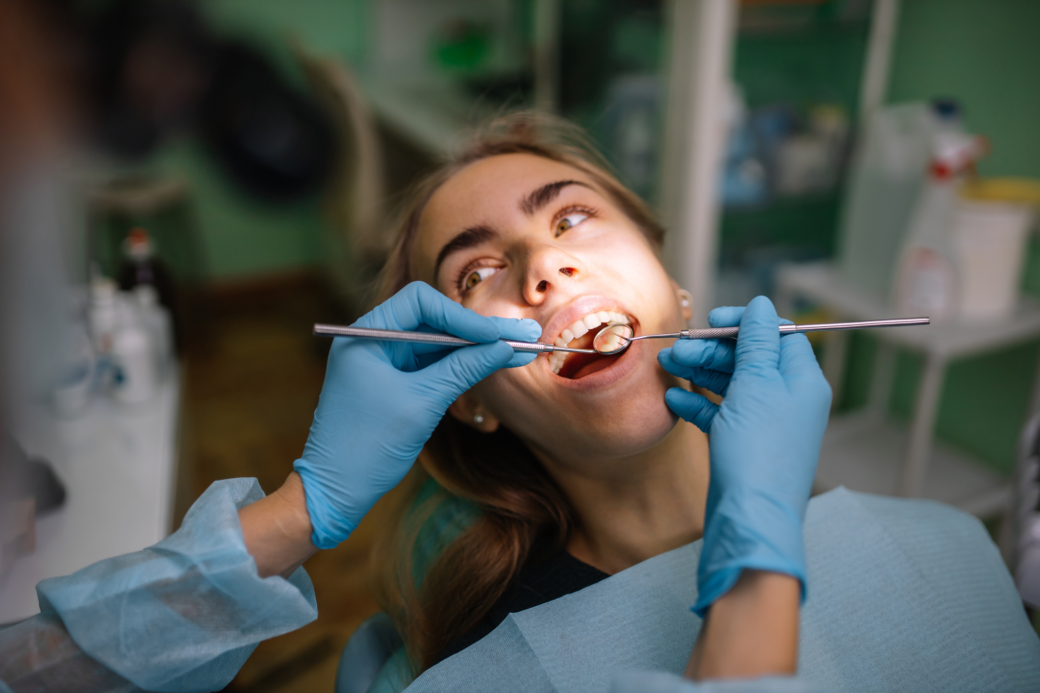 A woman is getting her teeth checked