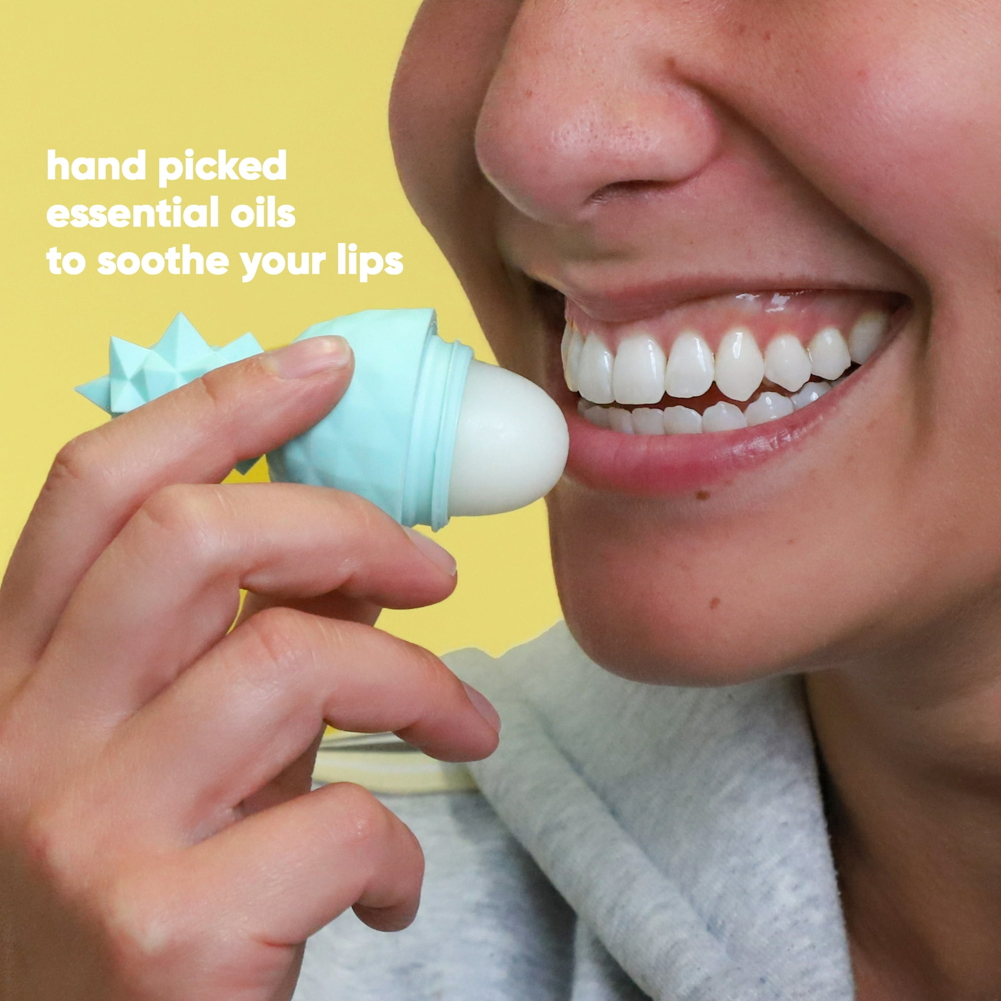 A person applying a green pineapple shaped lip balm